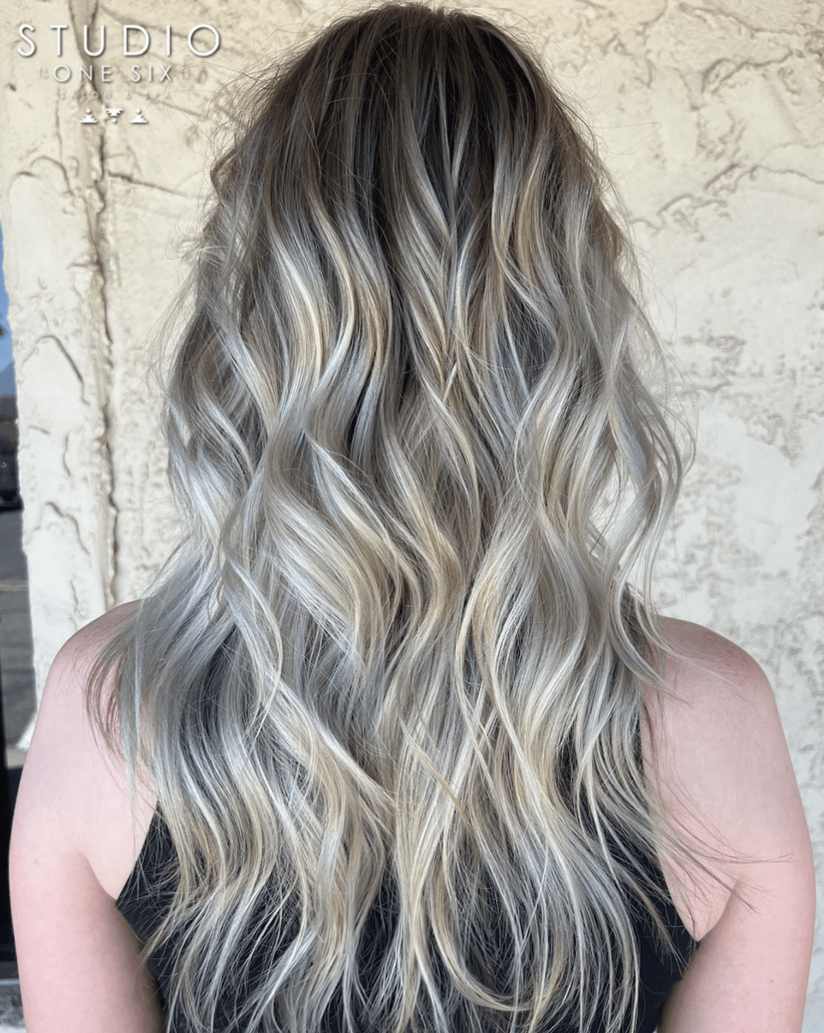 Silver ash balayage blended down from a dark root, colored at Studio One Six in Las Cruces